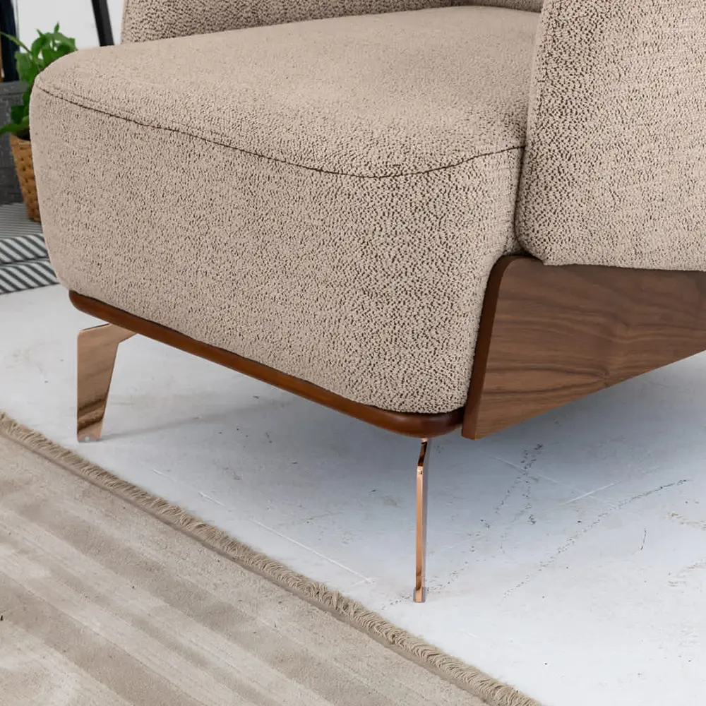 Close-up of Lavin armchair rose gold metal leg and wood veneer base detail – Asbar Furniture
