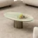 Green oval coffee table styled with cream bouclé seating in a modern living room – Asbar Furniture
